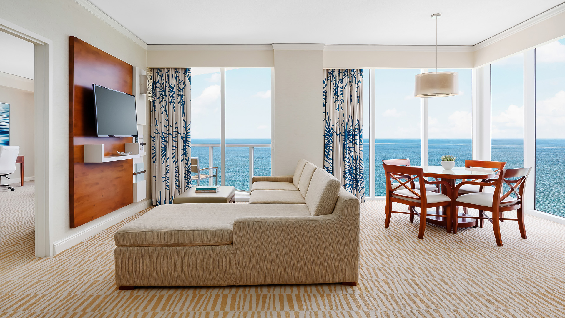 a living room with a couch and a table and chairs