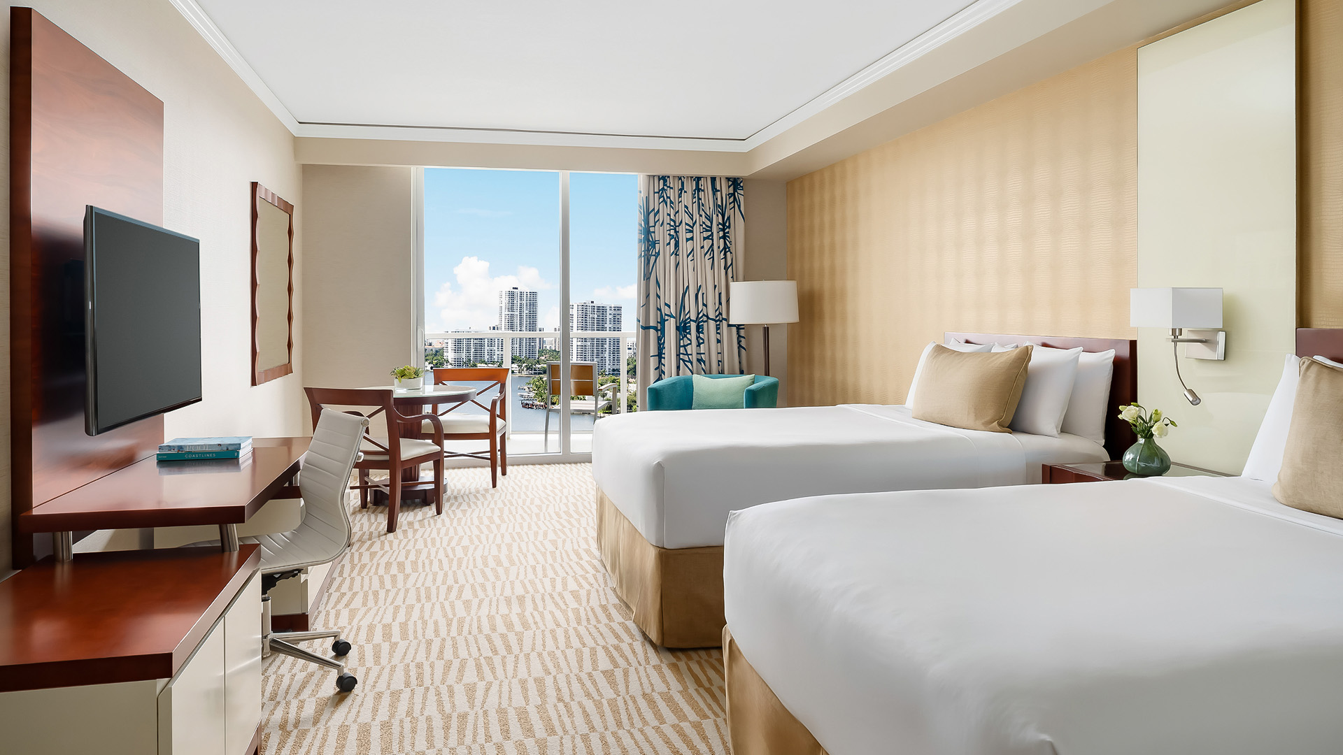a hotel room with two beds and a desk