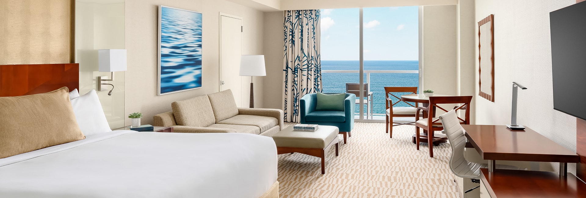 a room with a bed and chairs and a table
