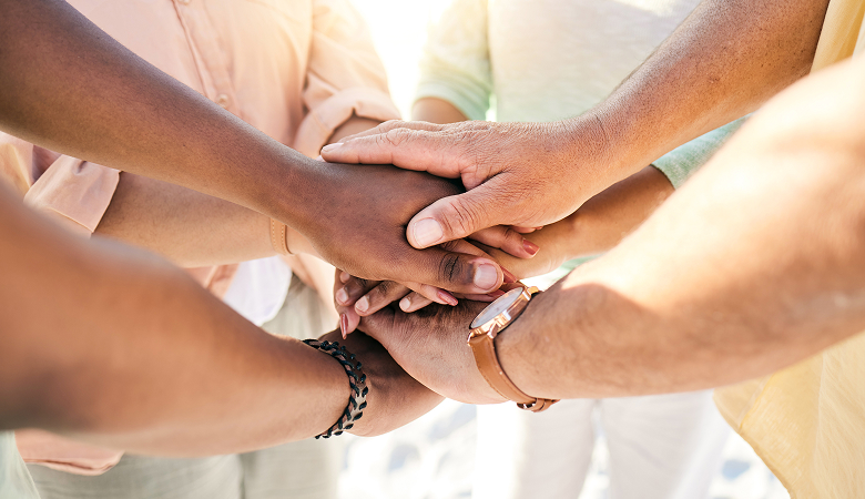 a group of people holding hands together