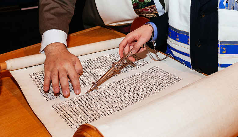 a person holding a pen over a book