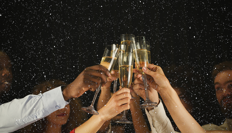 a group of people holding champagne glasses