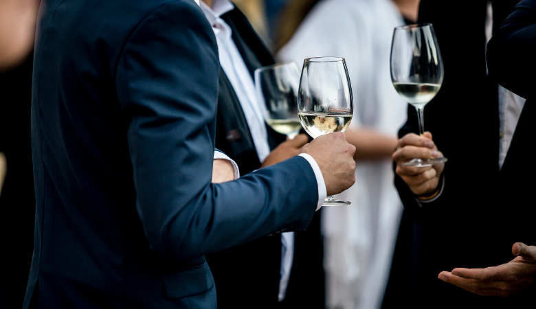 a group of people holding wine glasses