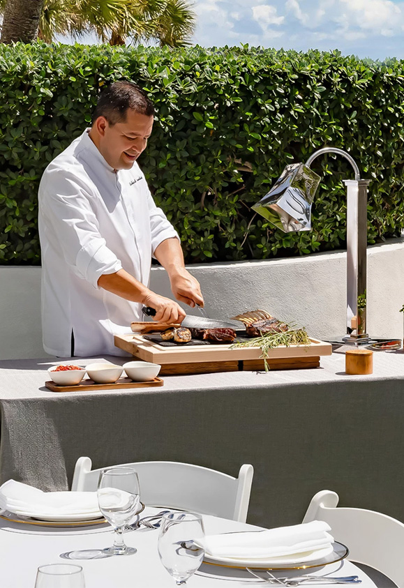 a man cutting meat on a board