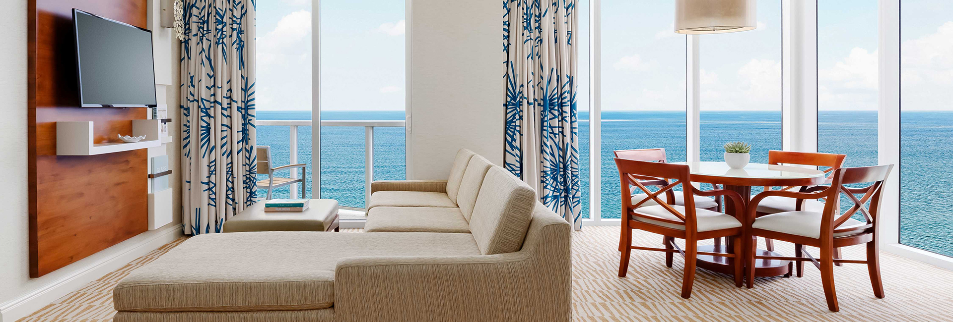 a living room with a table and chairs and a table with chairs and a table with chairs