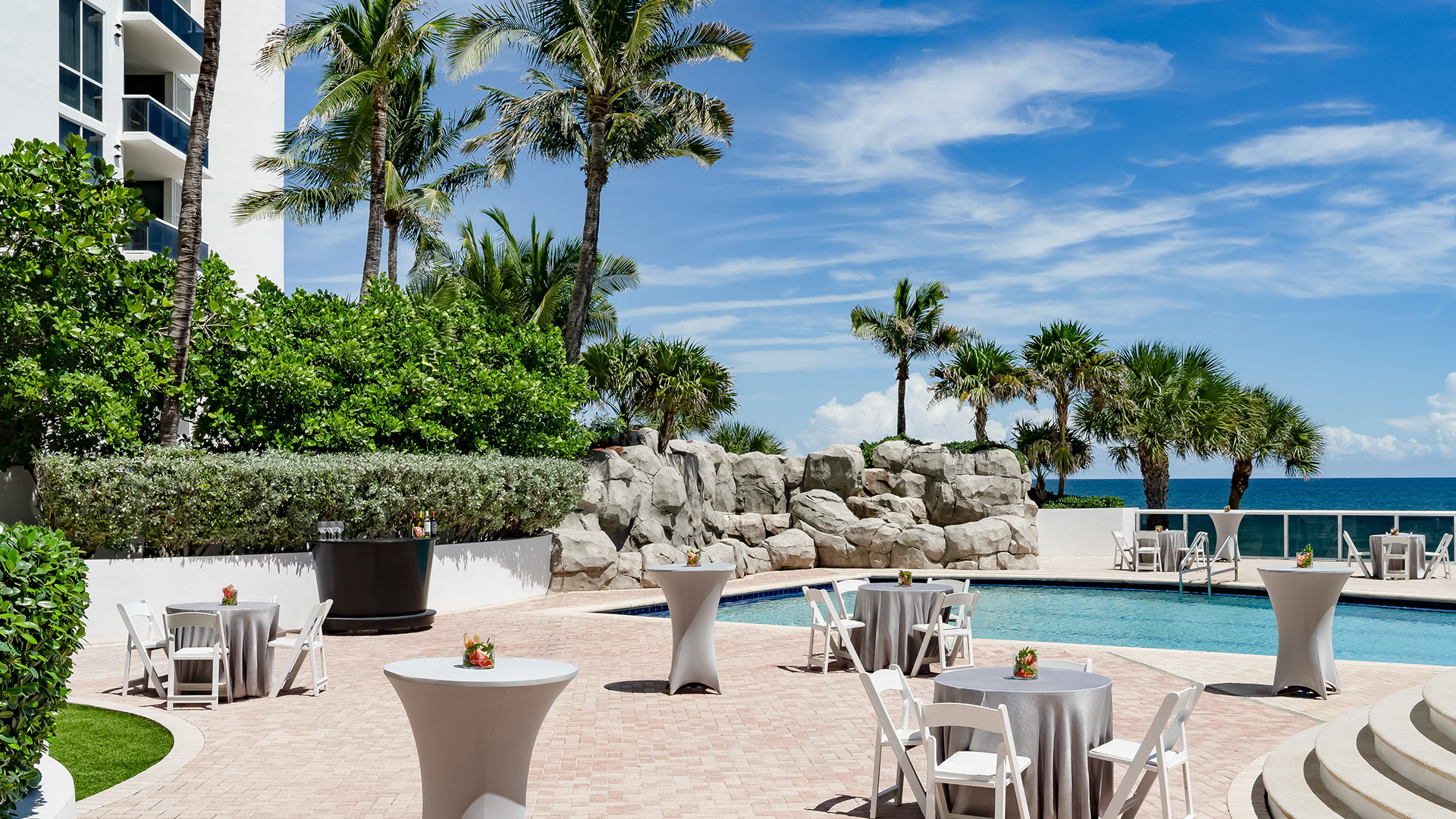 a pool with tables and chairs