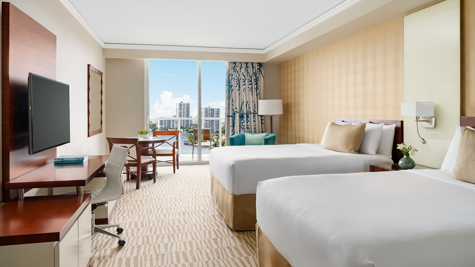 a hotel room with two beds and a desk