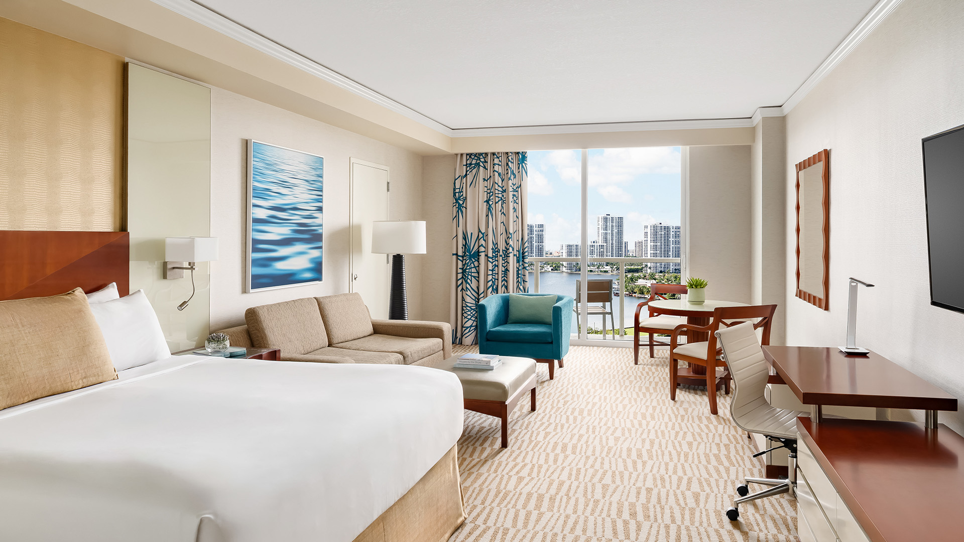 a hotel room with a bed and chairs