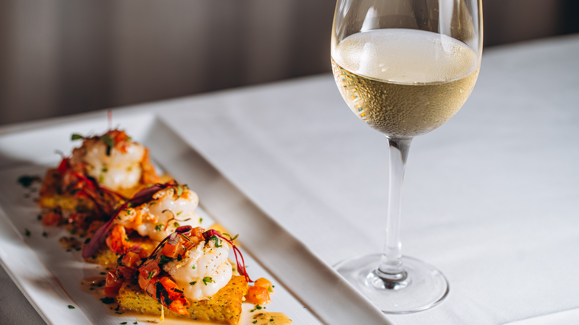 a plate of food and a glass of wine