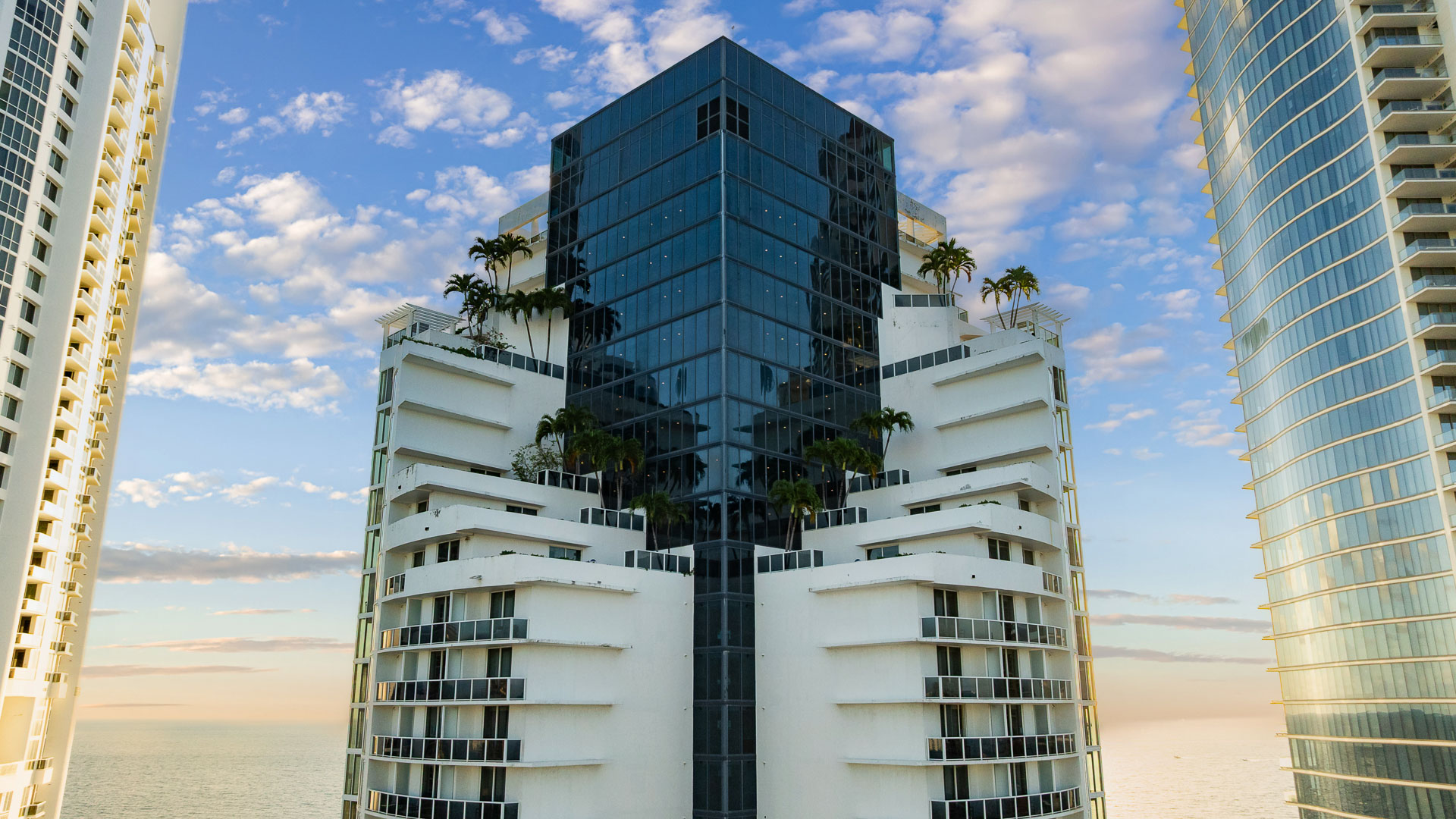 a building with palm trees on the side