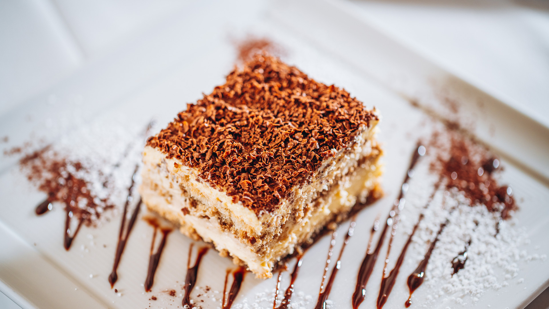a piece of cake with chocolate topping on a plate