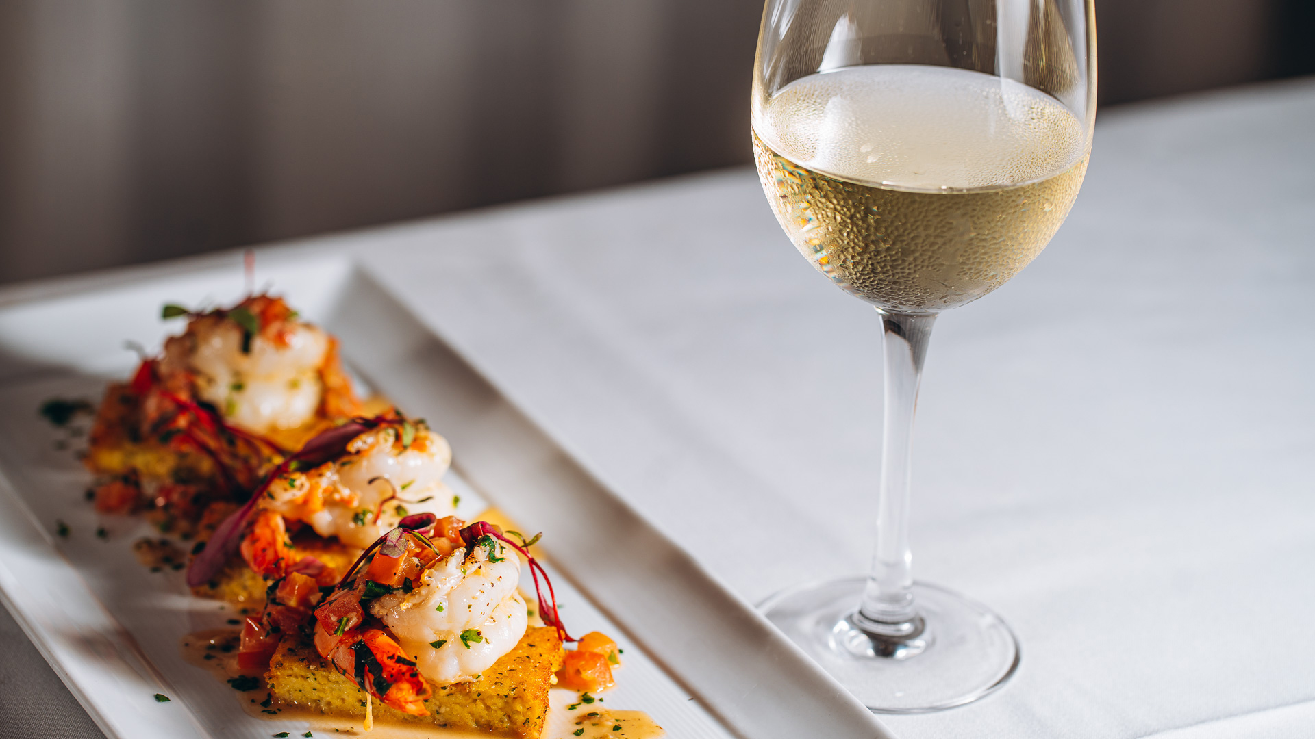 a plate of food and a glass of wine