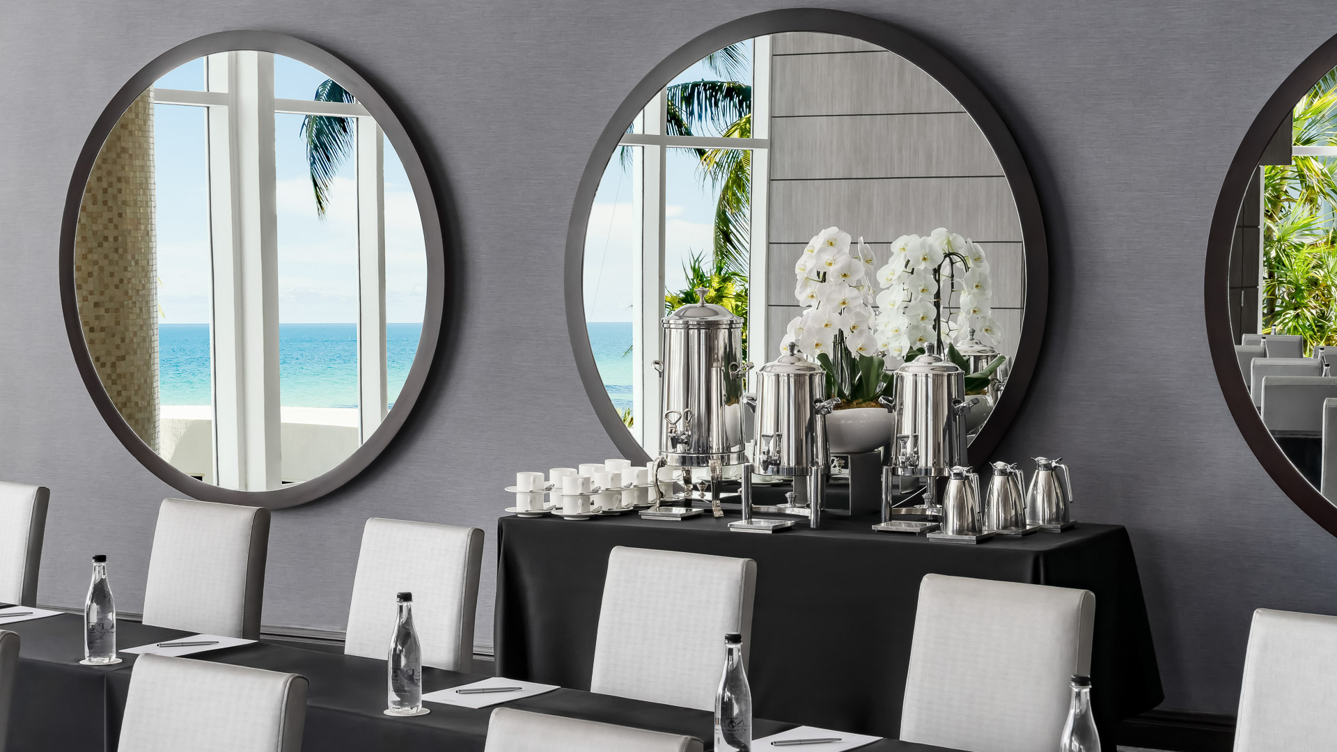 a table with a mirror and a large mirror on the wall