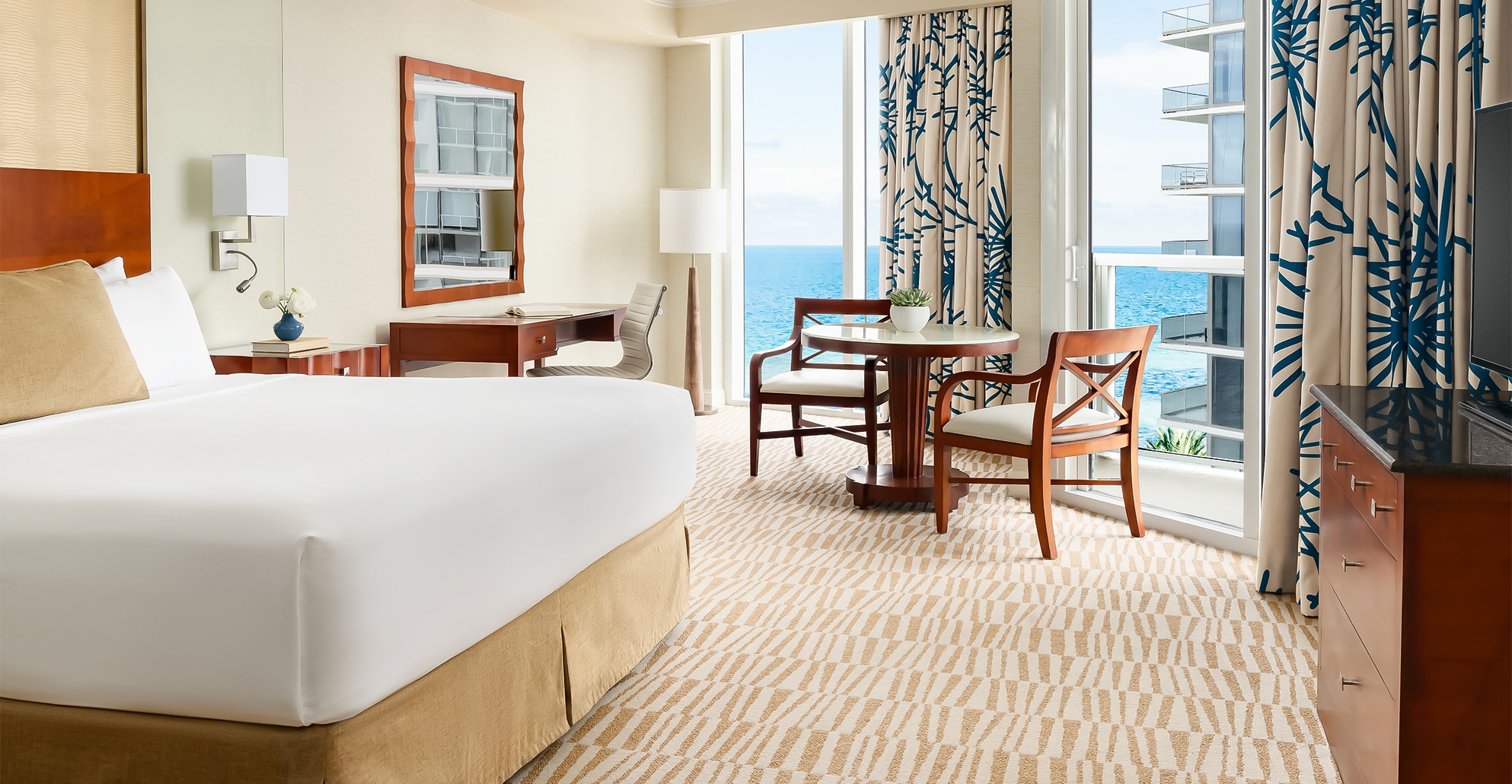 a room with a bed and chairs and a table