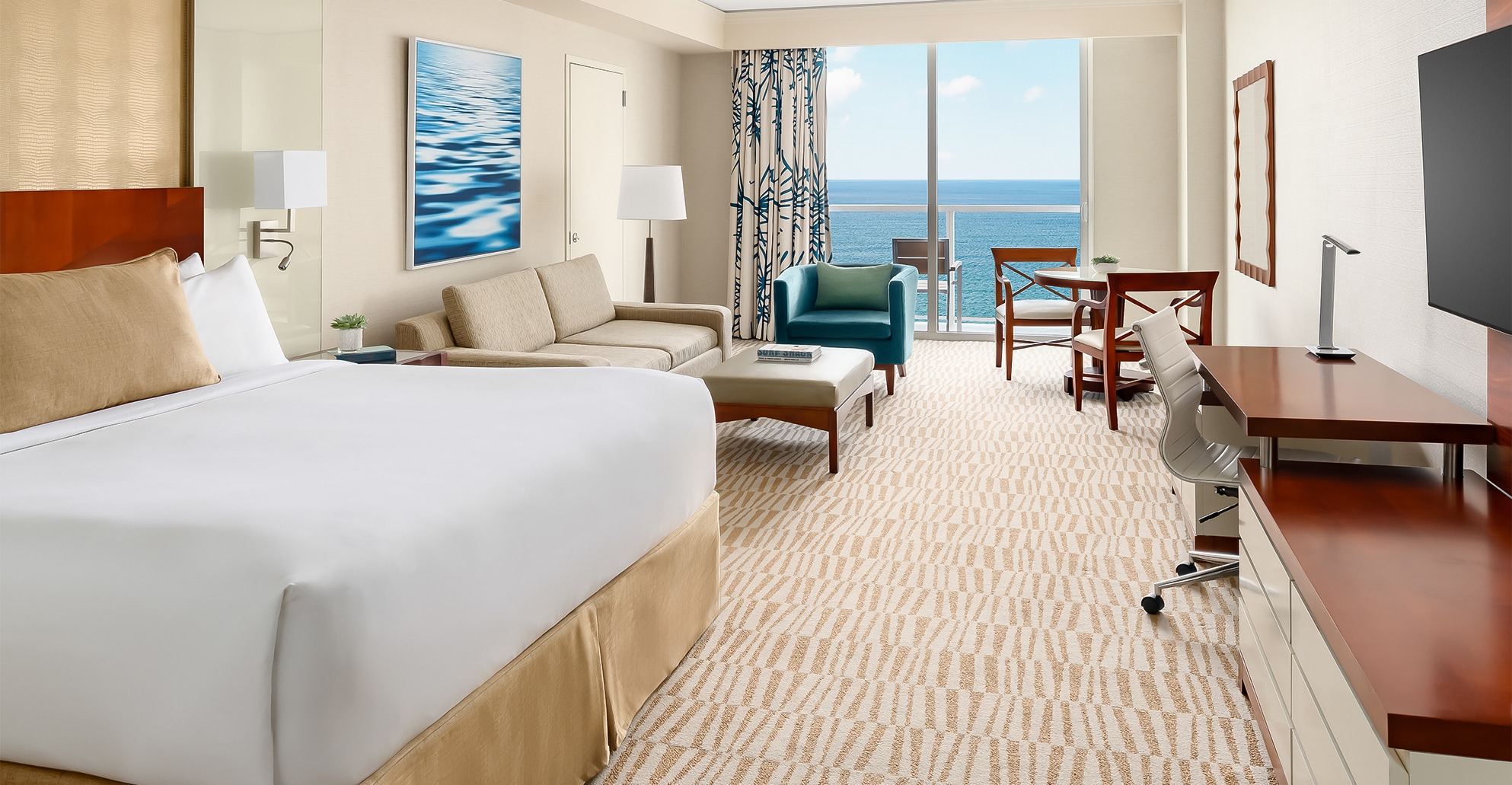 a room with a large bed and a couch and chairs