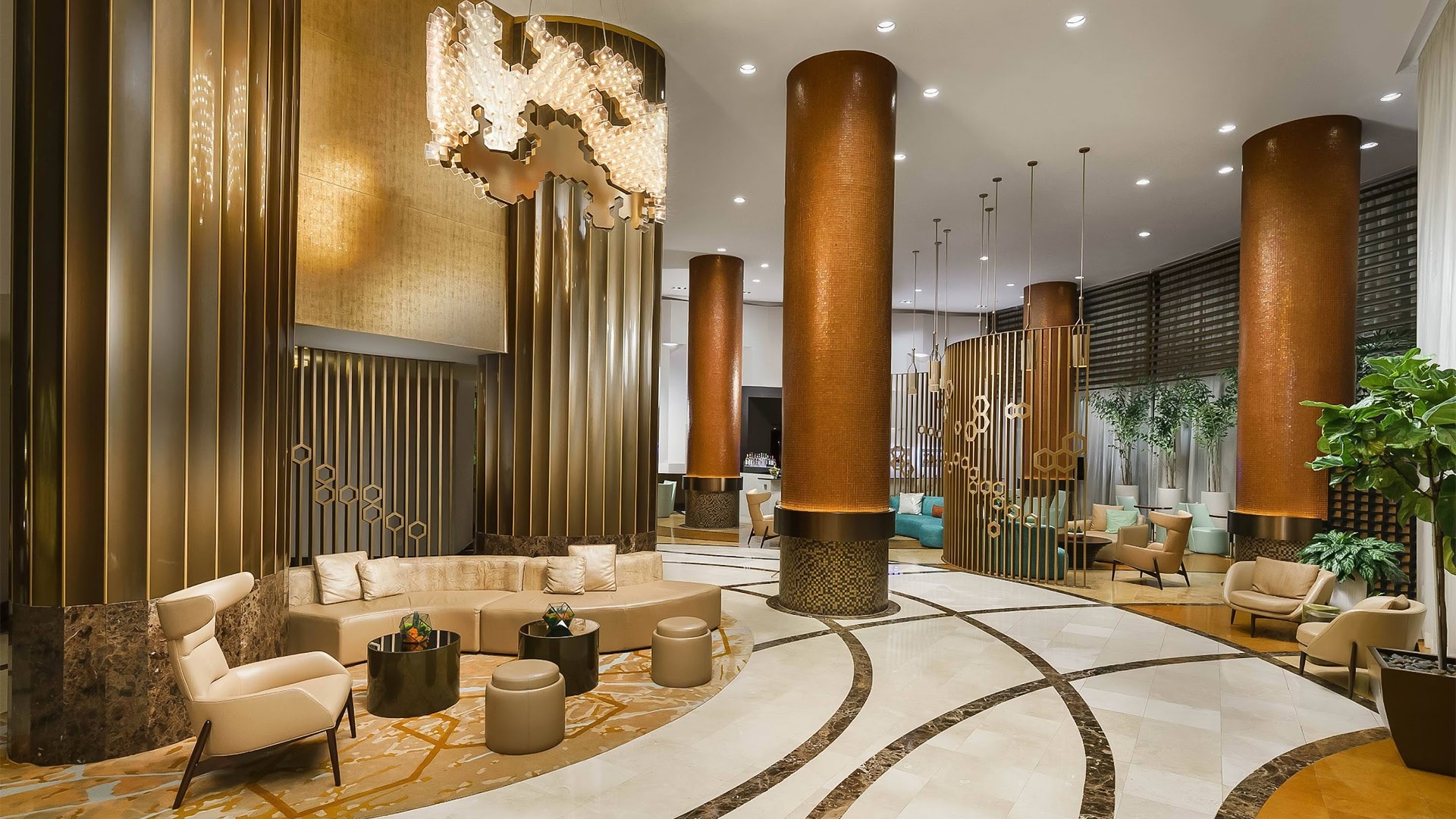 a lobby with a large round ceiling and columns