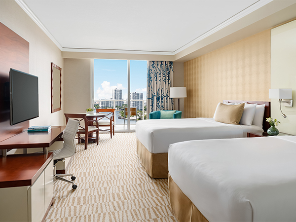 a room with two beds and a television