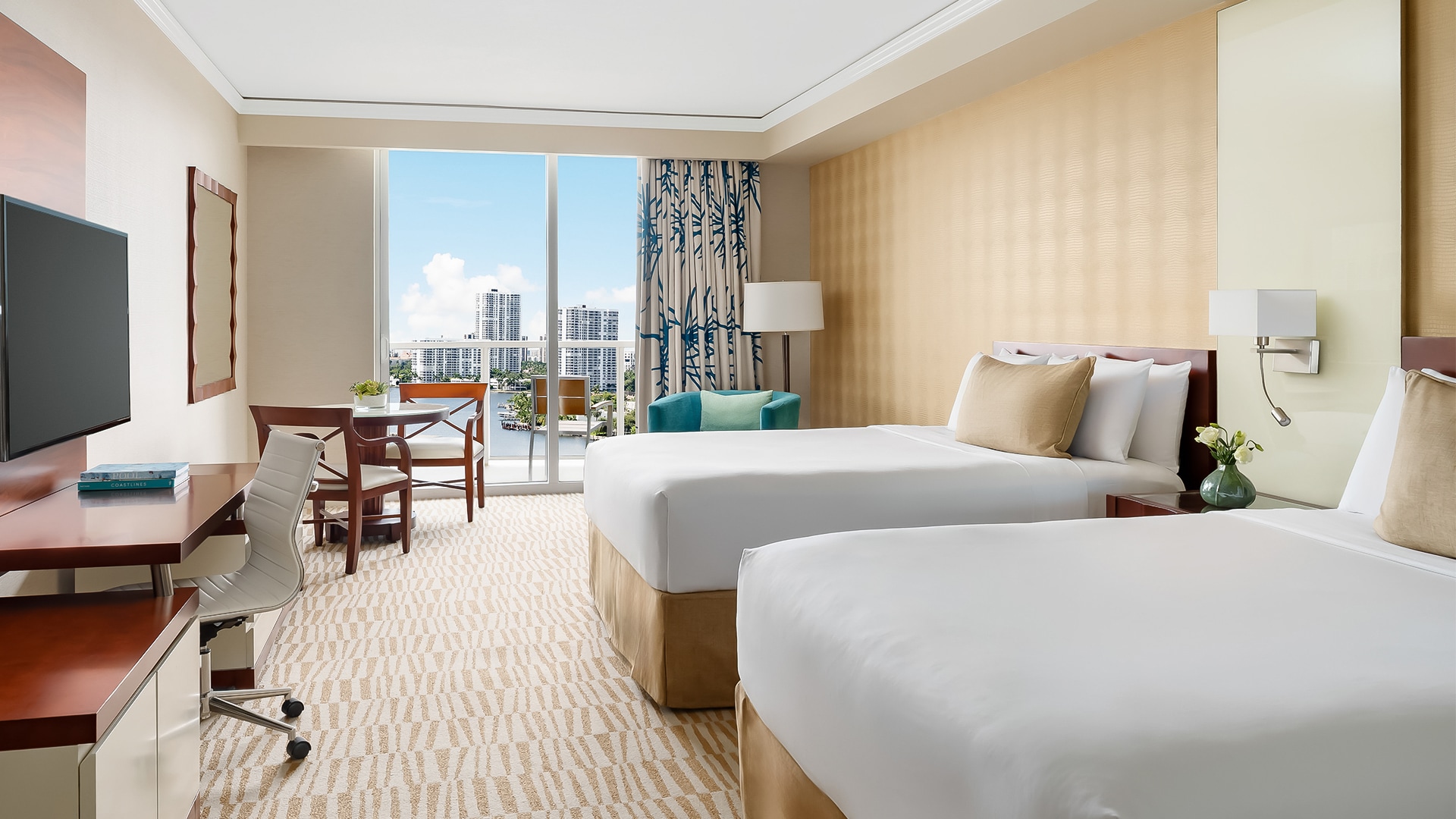 a hotel room with two beds and a table