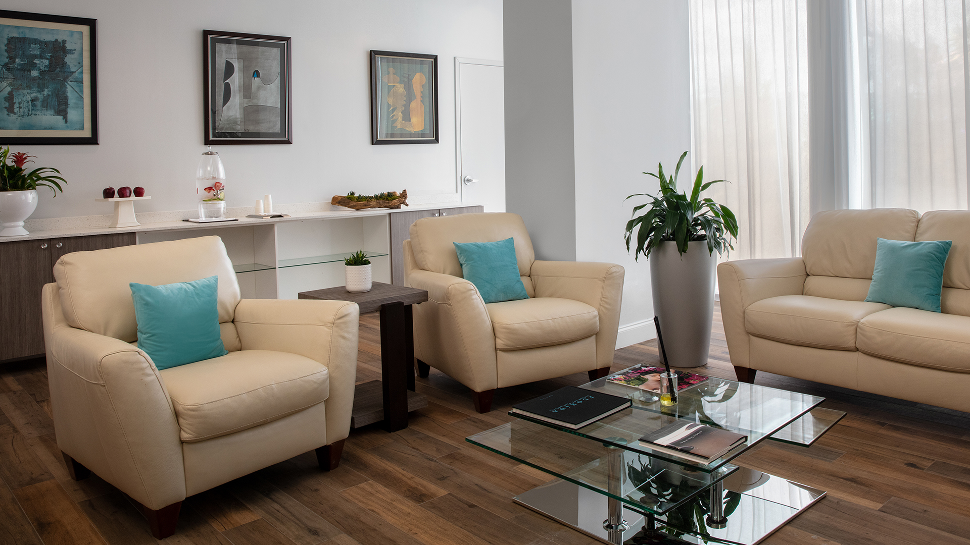 a room with white chairs and a glass coffee table