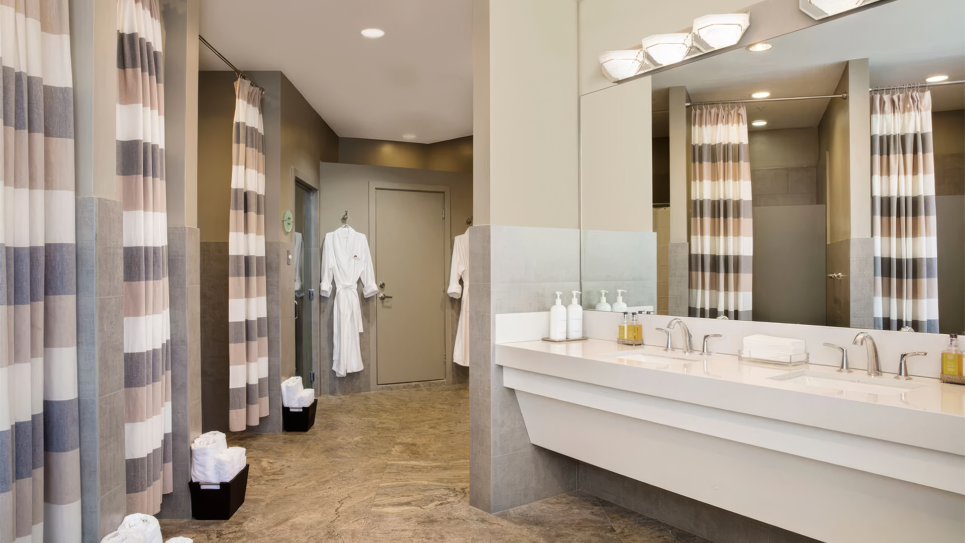a bathroom with a large mirror and a sink