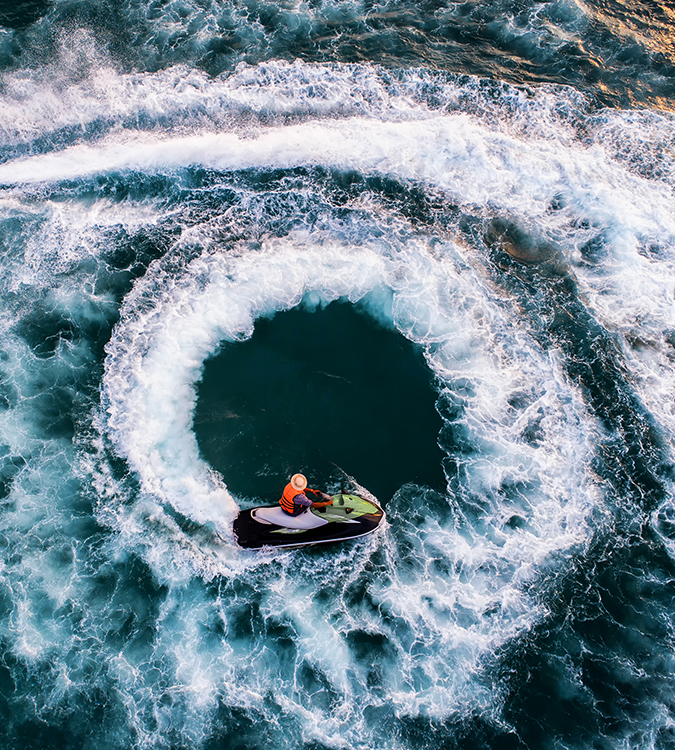 a person on a boat in a swirl of water