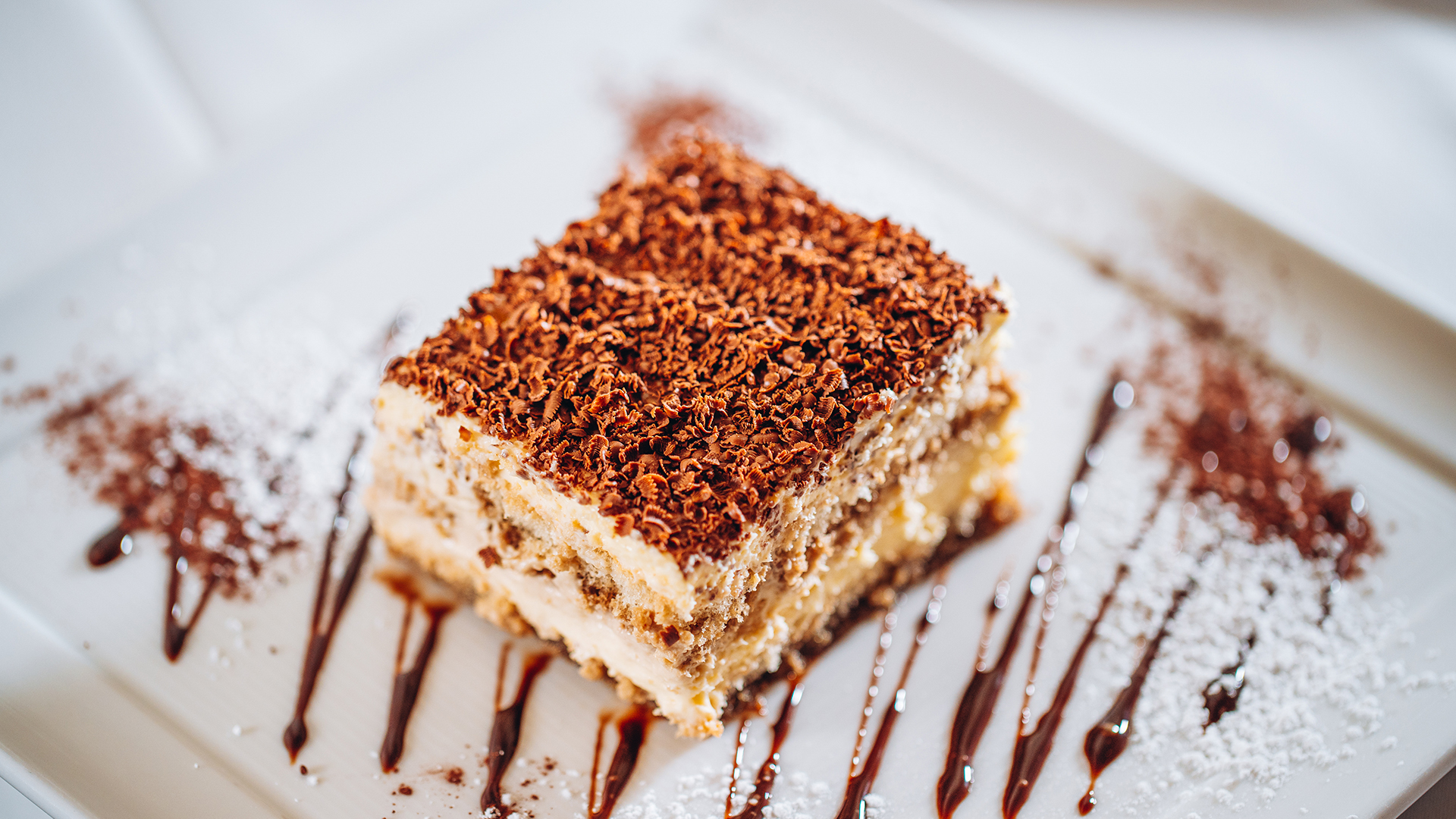a piece of cake with chocolate shavings on a plate