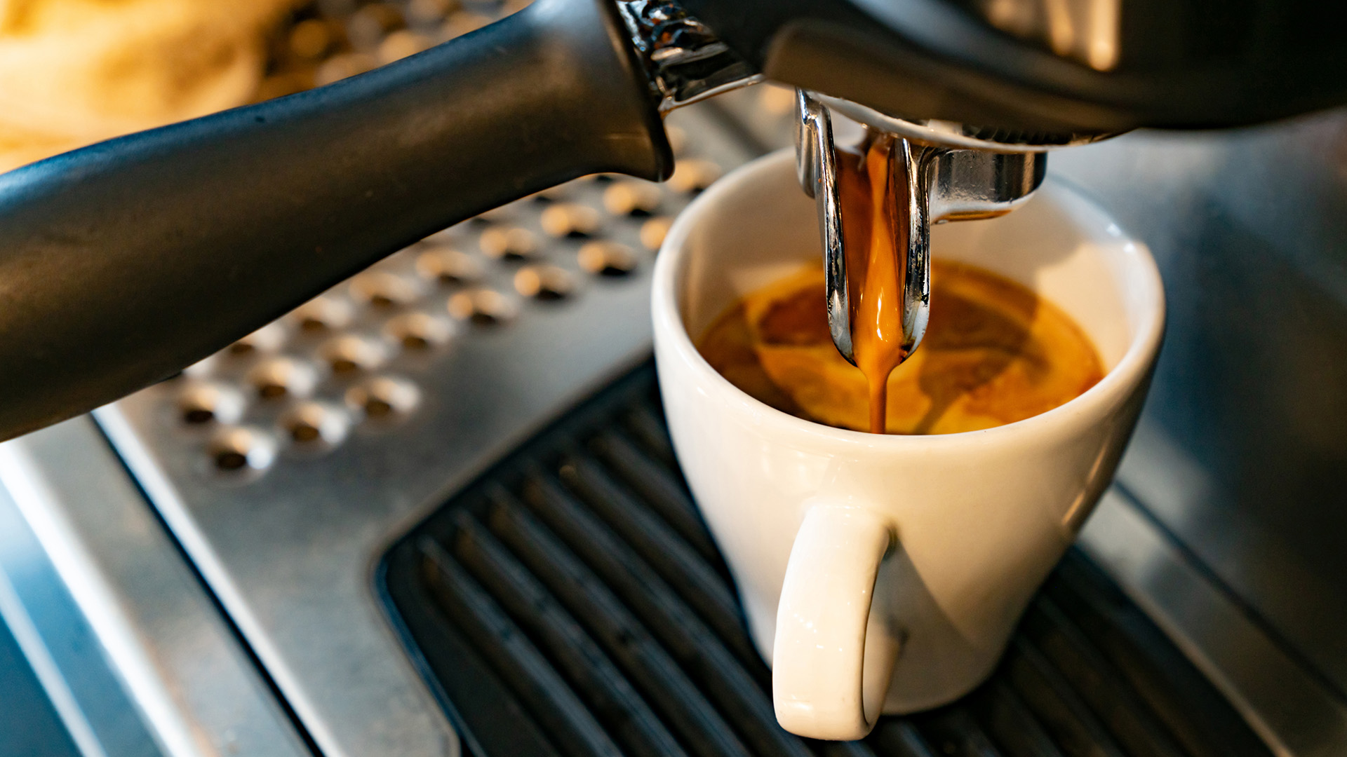a espresso machine pouring coffee into a cup
