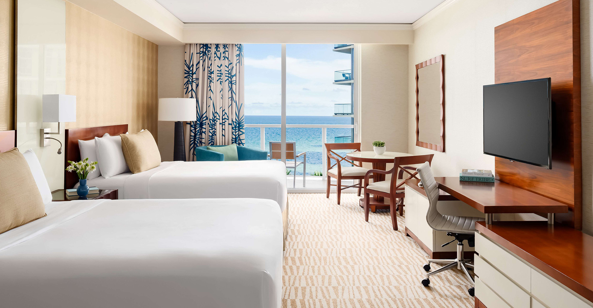 a hotel room with two beds and a table and chairs