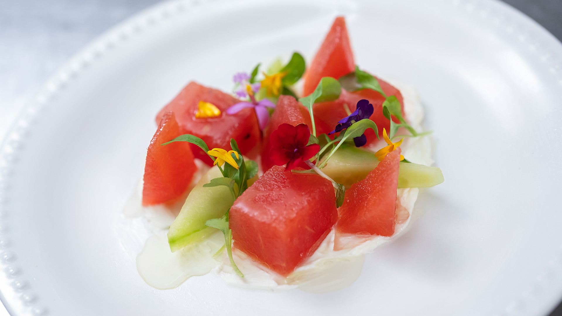 a plate of fruit and flowers