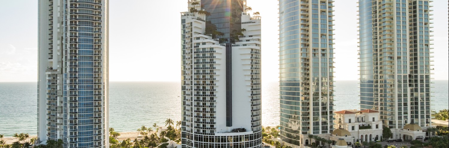 a tall buildings next to a body of water