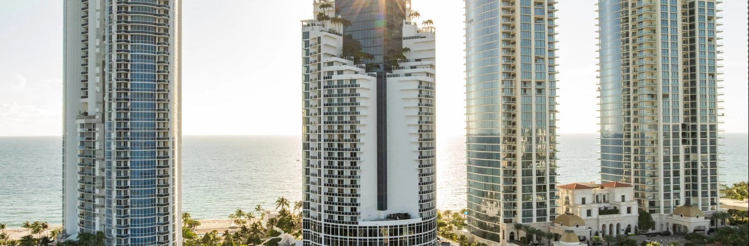 a tall buildings next to a body of water
