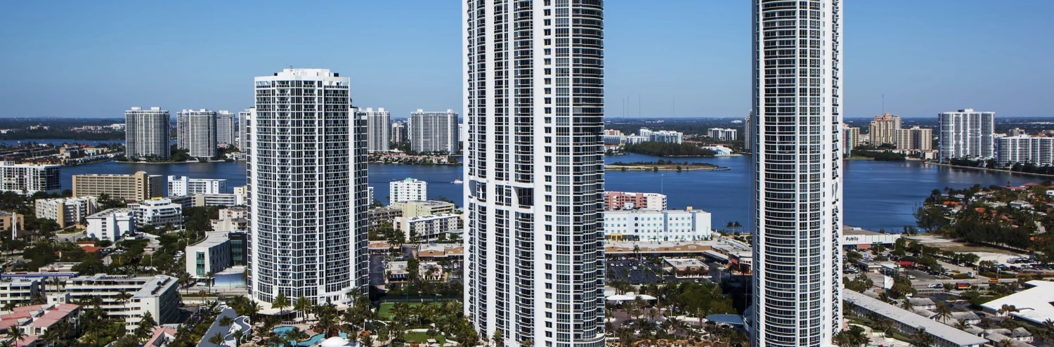 a group of tall buildings next to a beach