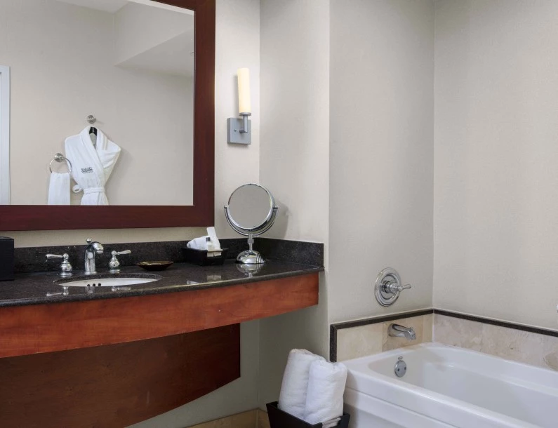 a bathroom with a bathtub and a mirror
