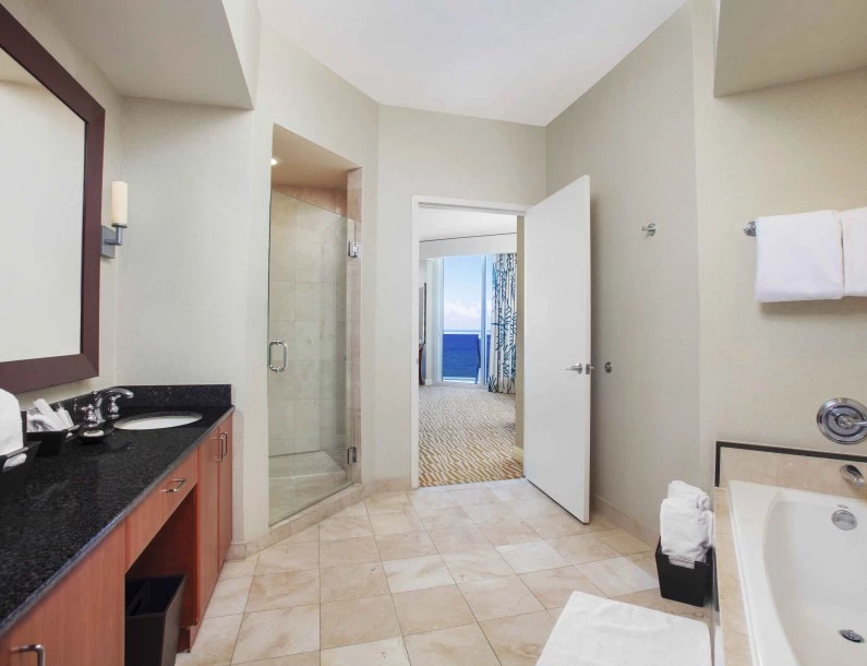 a bathroom with a glass shower and sink
