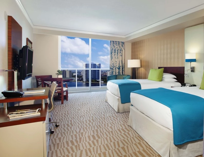a hotel room with two beds and a television