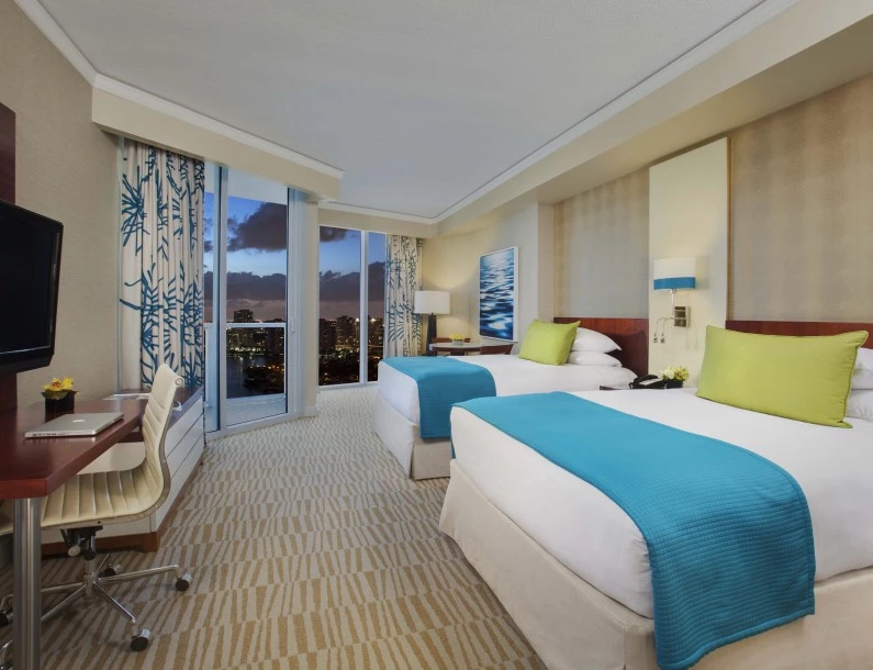 a hotel room with two beds and a desk