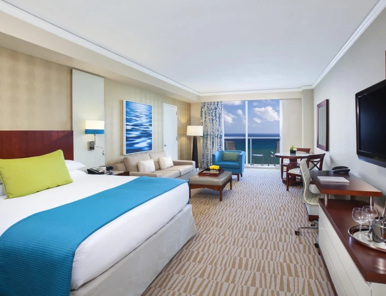 a room with a bed and a table and chairs