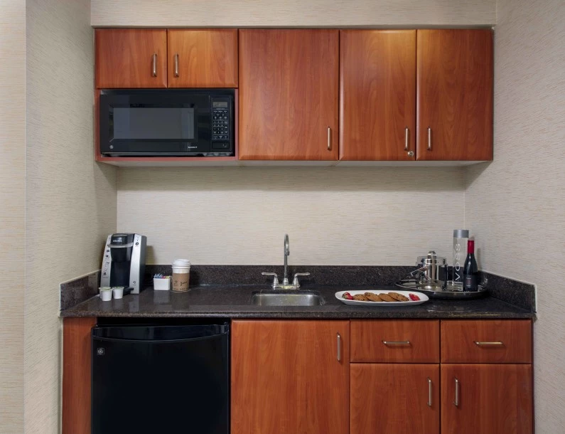 a kitchen with a microwave and food on the counter
