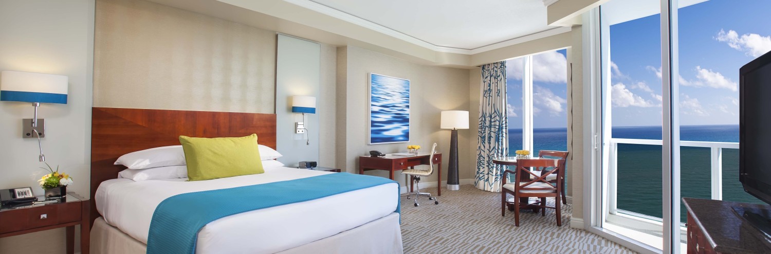 a hotel room with a large bed and a table and chairs