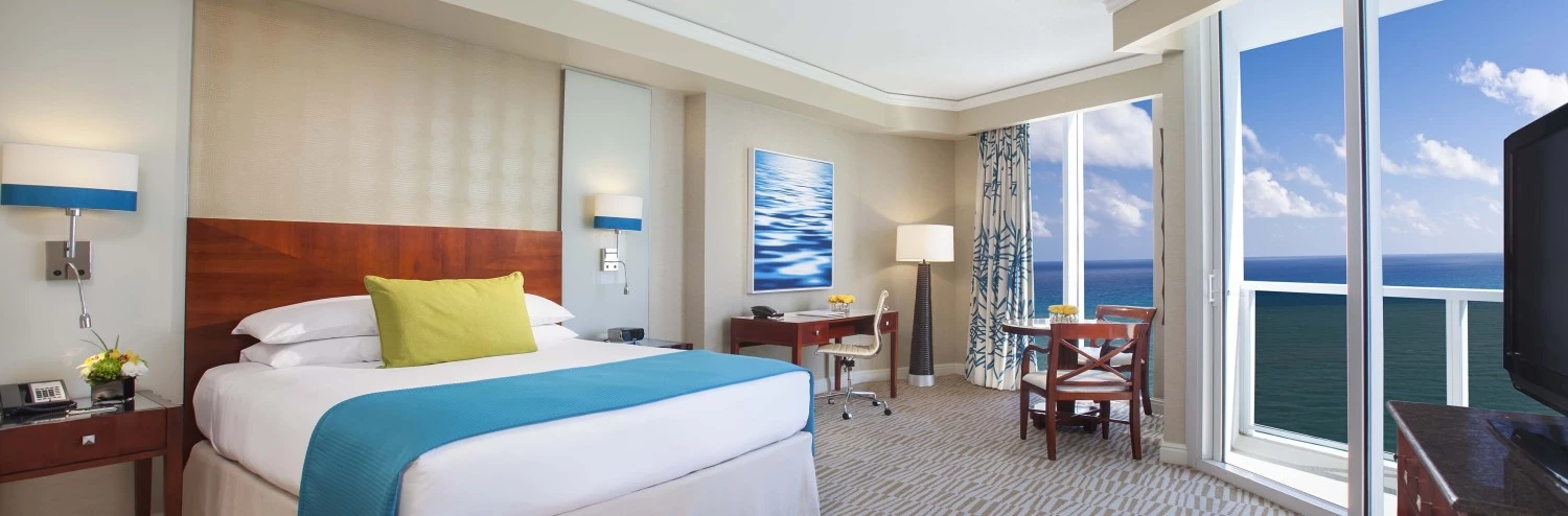 a hotel room with a large bed and a table and chairs