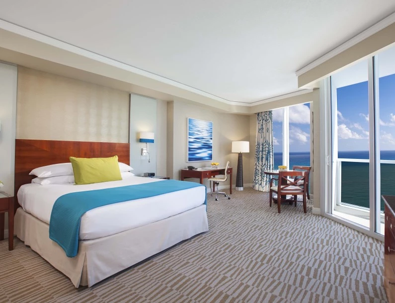 a hotel room with a large bed and a table and chairs