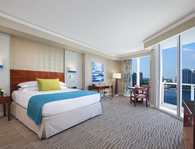 a room with a bed and a table and chairs
