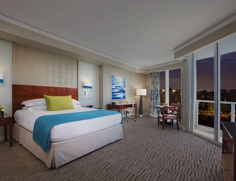 a hotel room with a bed and a table and chairs