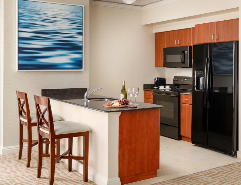 a kitchen with a black refrigerator and a black stove