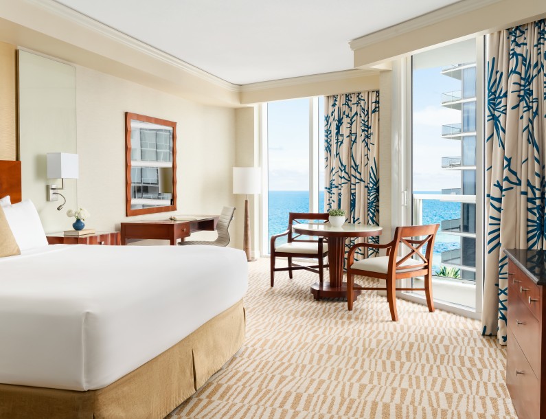 a room with a bed and chairs and a table