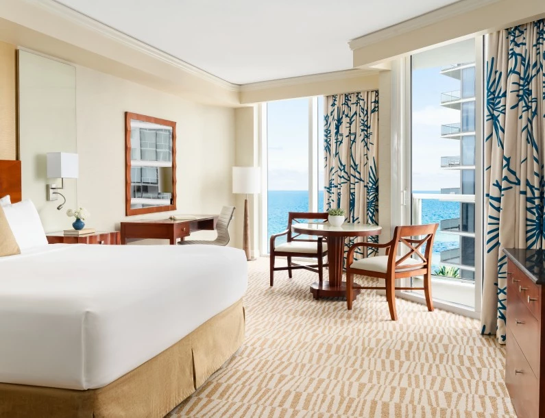 a room with a bed and chairs and a table