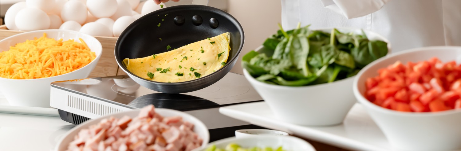 a person cooking omelette in a pan