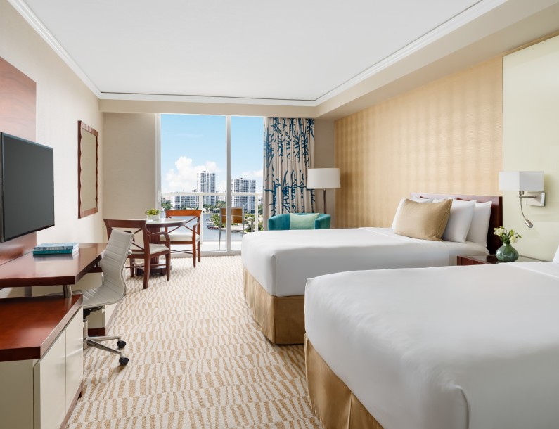 a hotel room with two beds and a desk