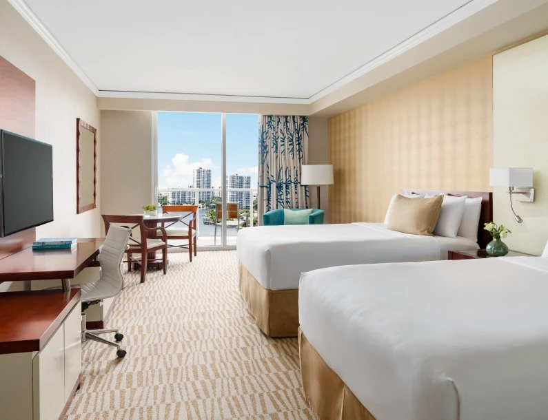 a hotel room with two beds and a desk