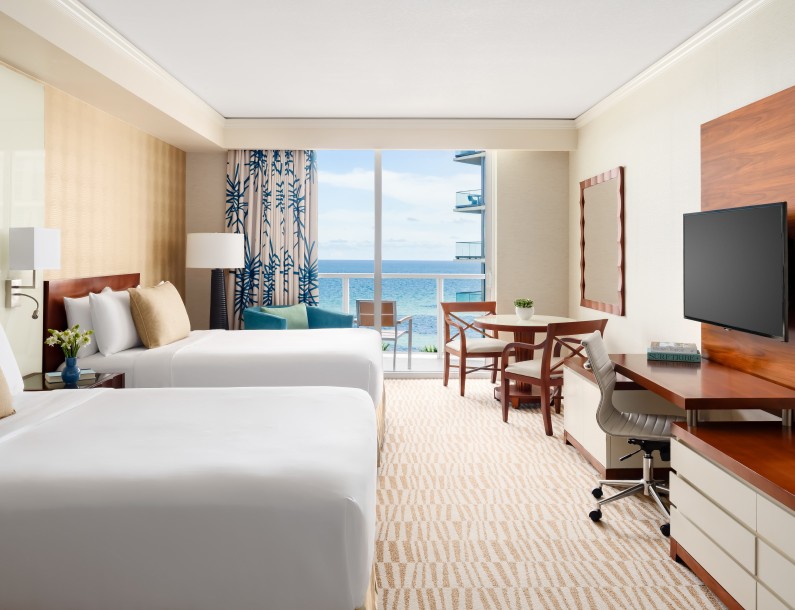 a room with two beds and a television